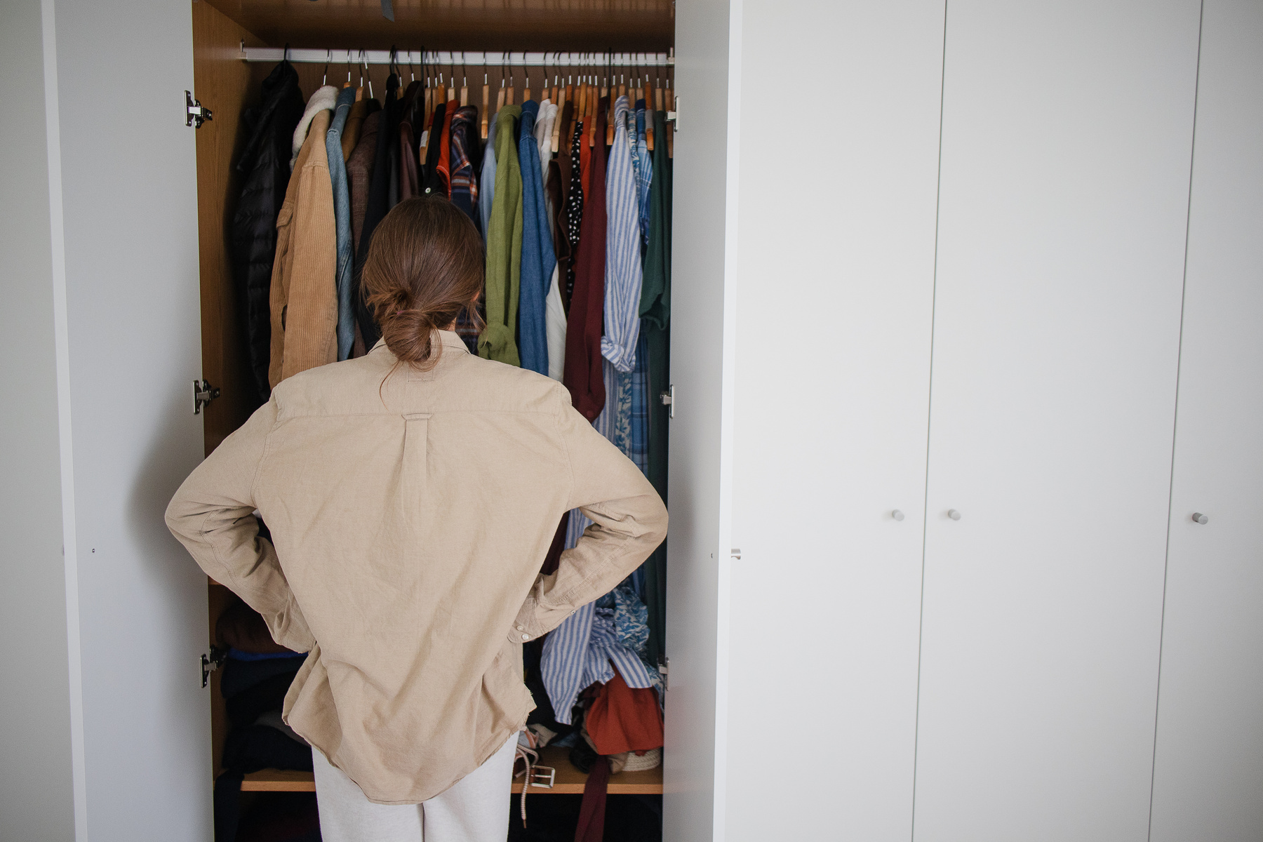 Woman Looking at a Full Closet