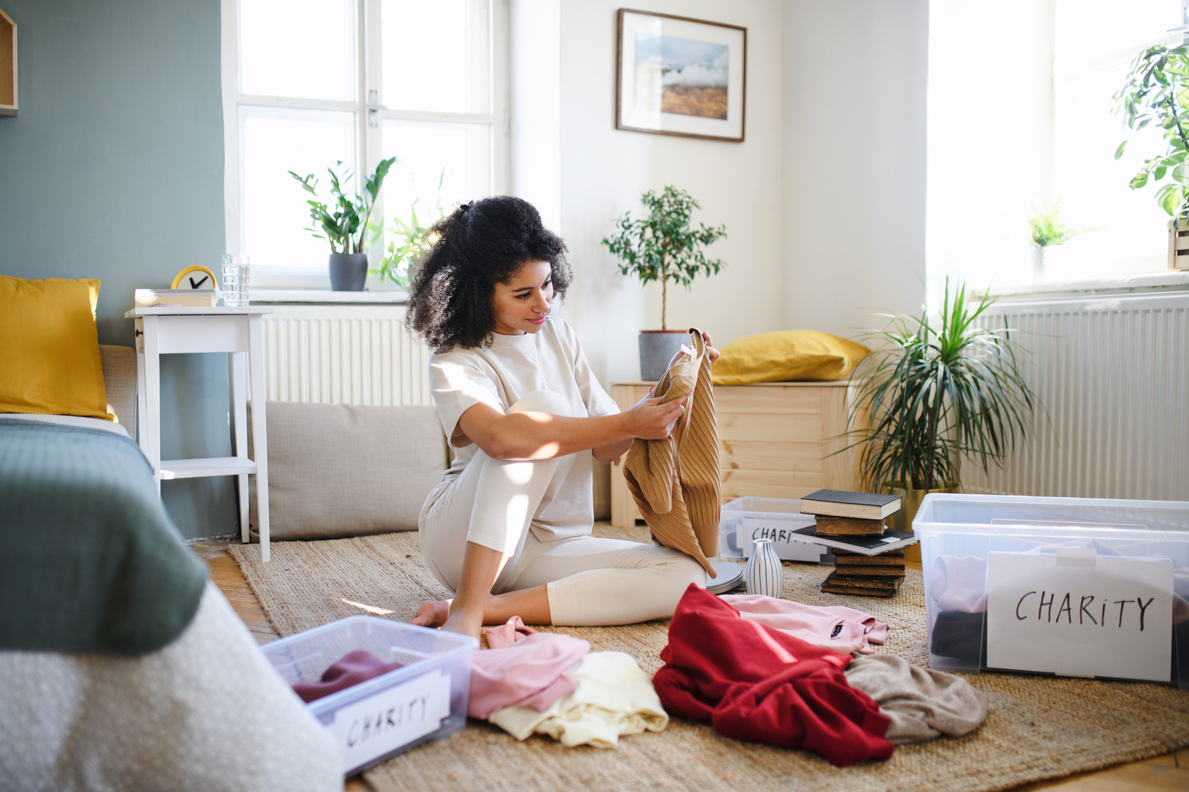 Young Woman Sorting Wardrobe Indoors at Home, Charity Donation Concept.